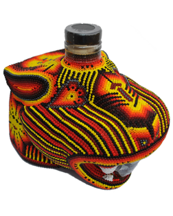 Image of a bottle of Chaquira Añejo Tequila with its colorful jaguar deign, featuring colors of red, orange, yellow and white.