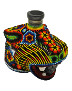 Image of a bottle of Chaquira Extra Añejo with its colorful jaguar deign, featuring colors of red, orange, yellow, green, blue and black.