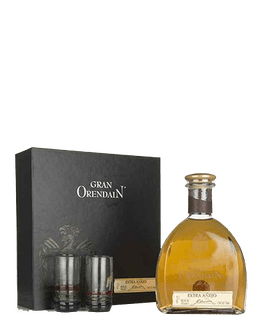 Image of a bottle of Gran Orendain Anejo Tequila, featuring a sleek design with small white label next to two shot glasses