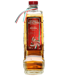 Image of a bottle of Joyas de Mexico Anejo Tequila, featuring a bottle design in the shape of the Mexican territory with a deep red label with red, white, and green accents.