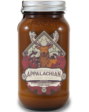 Image of a jar of Sugarlands Appalachian Eggnog Sippin' Cream Liqueur featuring a sleek design with a red and white label with a deer and white accents.